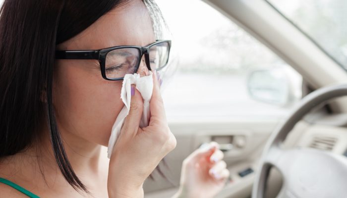 woman-driver-sneezing-in-the-car