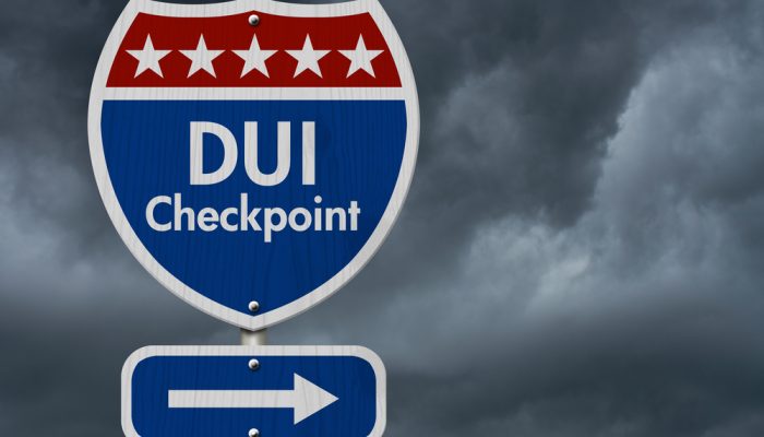 American DUI Checkpoint Highway Road Sign, Red, White and Blue American Highway Sign with words DUI Checkpoint with stormy sky background