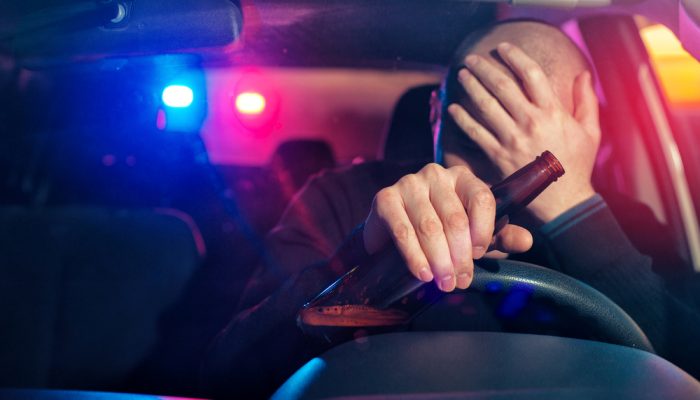 Upset male driver is caught driving under alcohol influence
