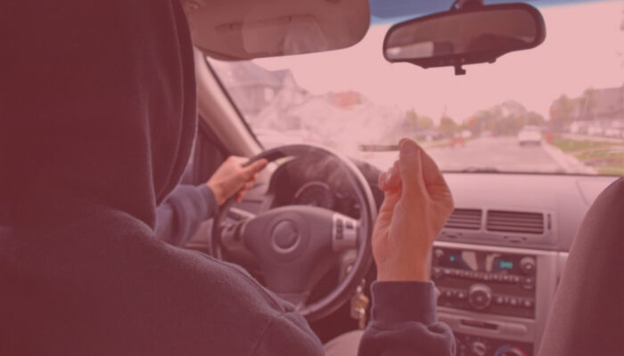 man smoking marijuana at the wheel