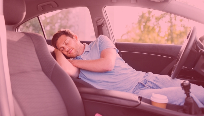 man asleep in car